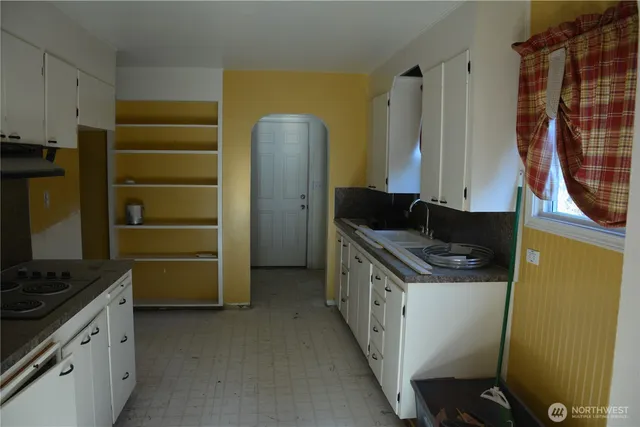 a kitchen with a stove and a refrigerator