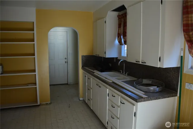 a kitchen with a refrigerator and a stove