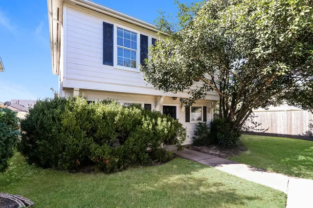 a view of a house with a yard and plants