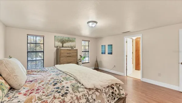 a bedroom with a large bed and a window