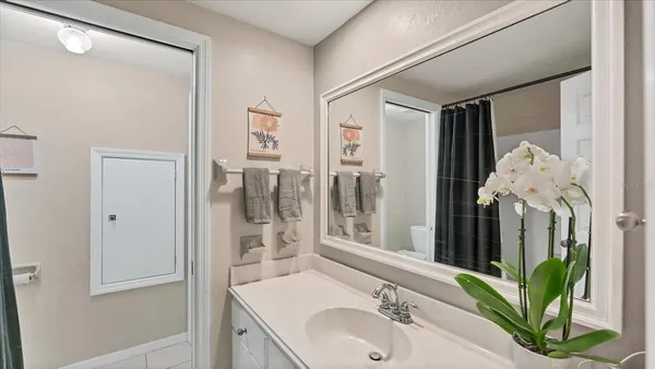 a bathroom with a sink vanity granite and a mirror