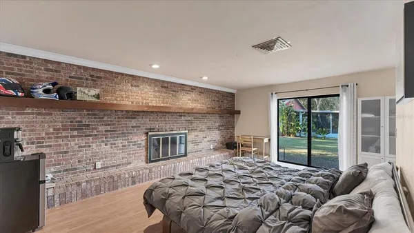 a bedroom with a bed and a fireplace