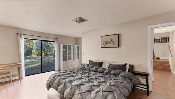 a large bed sitting in a bedroom next to a window