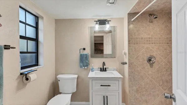 a bathroom with a toilet sink and shower