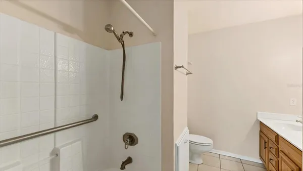 a bathroom with a granite countertop shower and a toilet