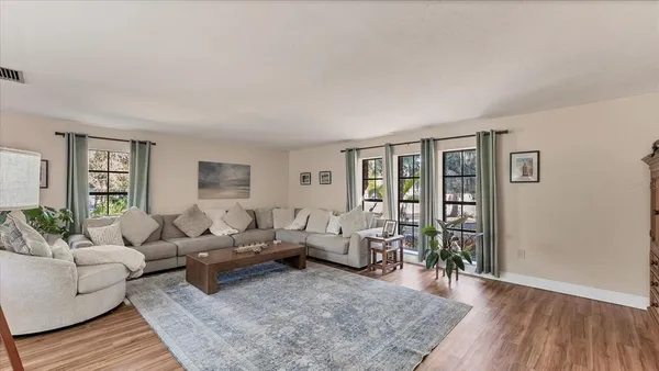 a living room with furniture and wooden floor