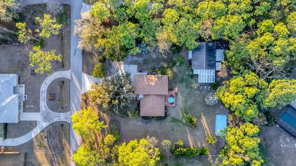 an aerial view of a house with a yard and garden