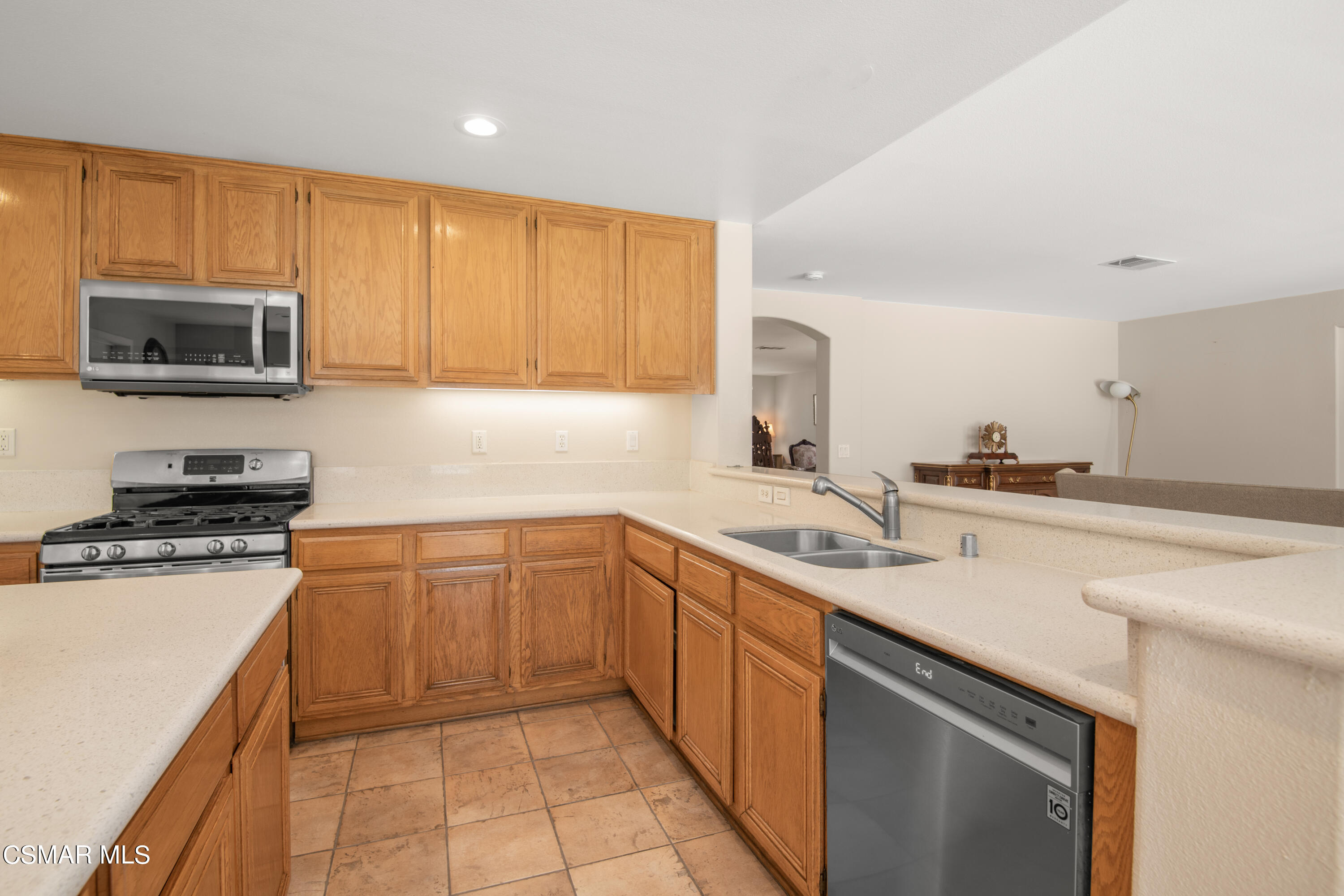 32645 The Old Road Castaic, CA 91384 - Photo 10 of 32 a kitchen with stainless steel appliances granite countertop a sink stove microwave and cabinets