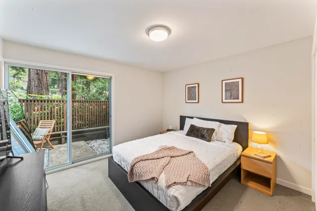 a bedroom with a bed and glass door