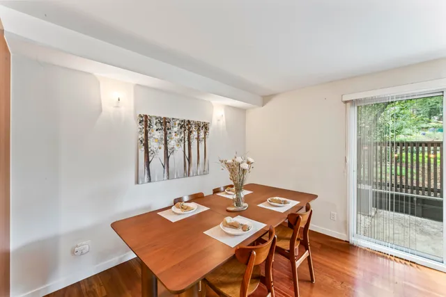 a view of a dining room with furniture window and wooden floor