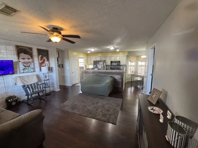 a kitchen with stainless steel appliances granite countertop a stove refrigerator and microwave