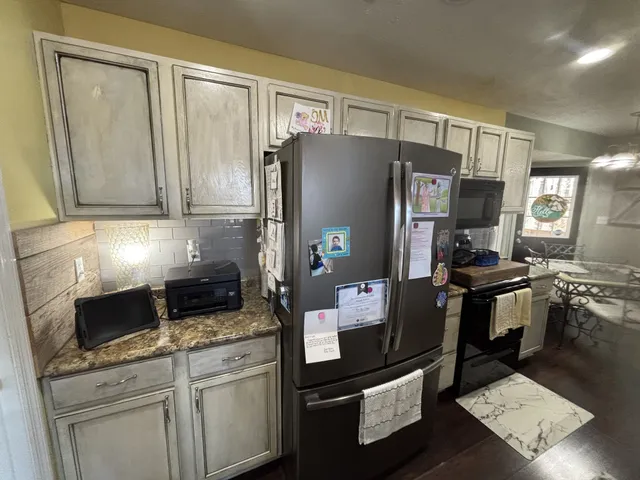 a kitchen with a sink and a mirror
