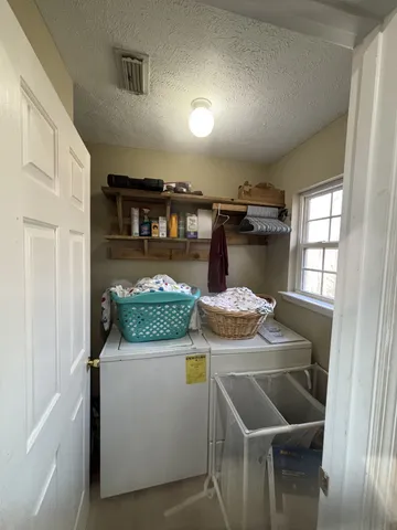 a view of a dining room with furniture and window