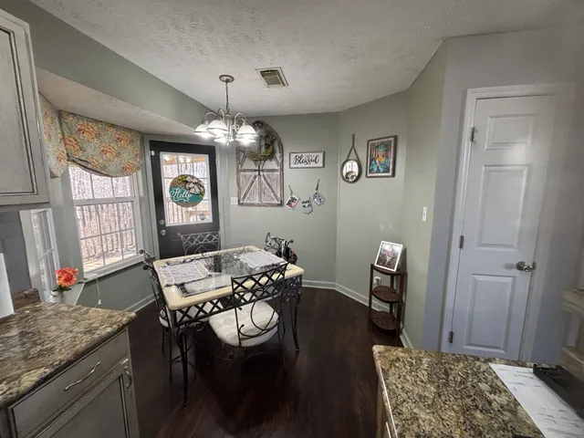 a bedroom with furniture and a large window