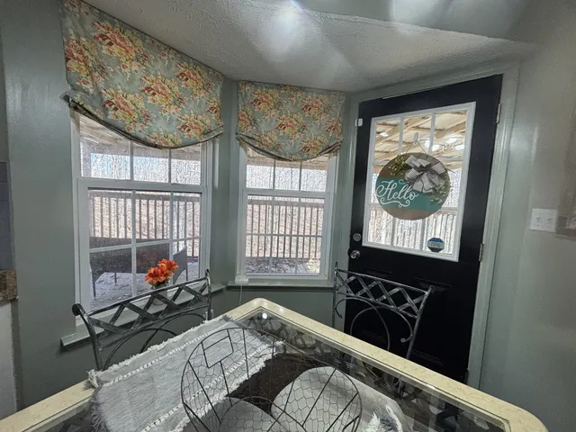 a large kitchen with stainless steel appliances granite countertop a sink stove and refrigerator