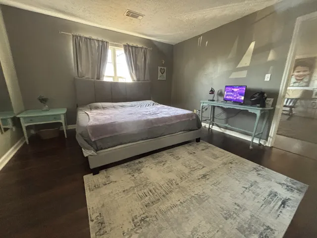 a bedroom with a bed and window