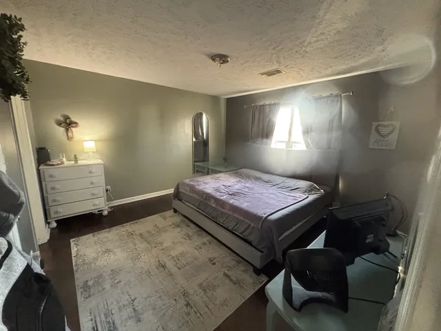 a bedroom with a bed and a mirror