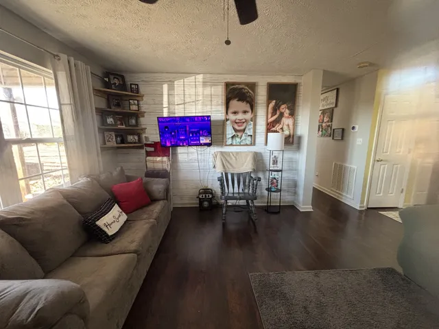 a living room with furniture and a chandelier
