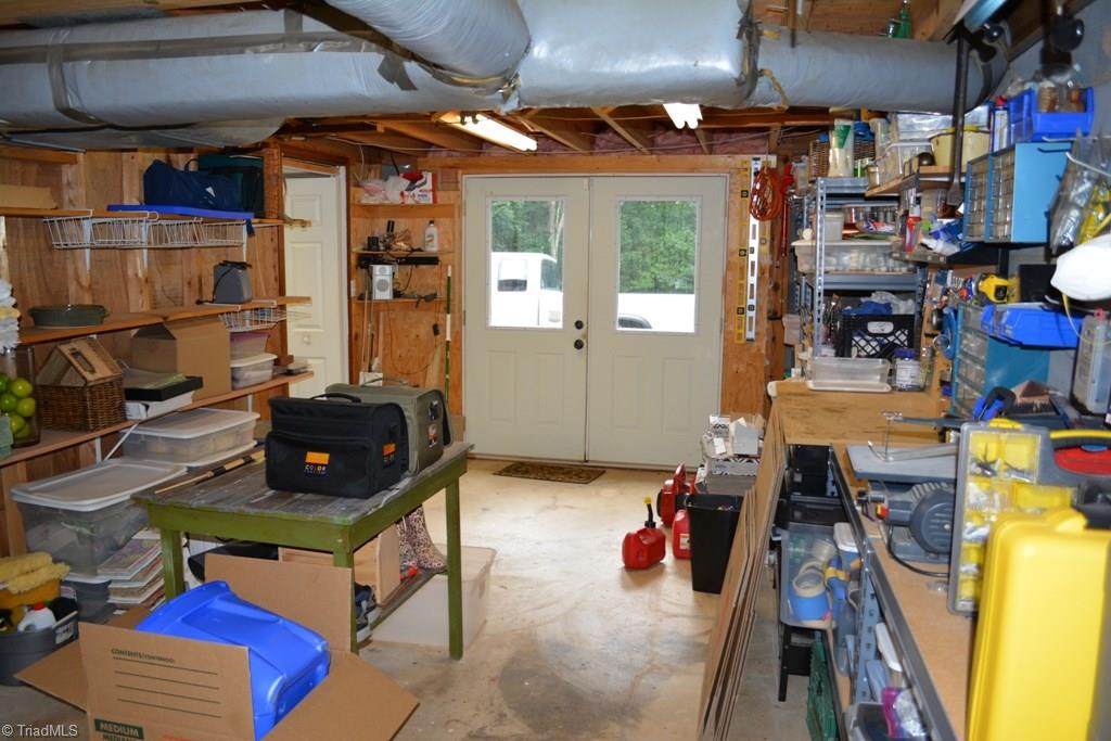 2582 Little Elkin Church Road Ronda, NC 28670 - Photo 23 of 30 About a third of the basement space is this shop / utility area. Double doors lead to the exterior parking in the rear of the home.