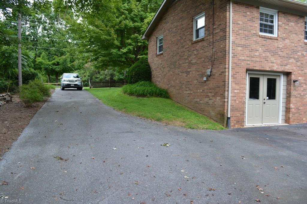 2582 Little Elkin Church Road Ronda, NC 28670 - Photo 25 of 30 Second paved drive to the right side of the home wraps around to the parking area in the rear.