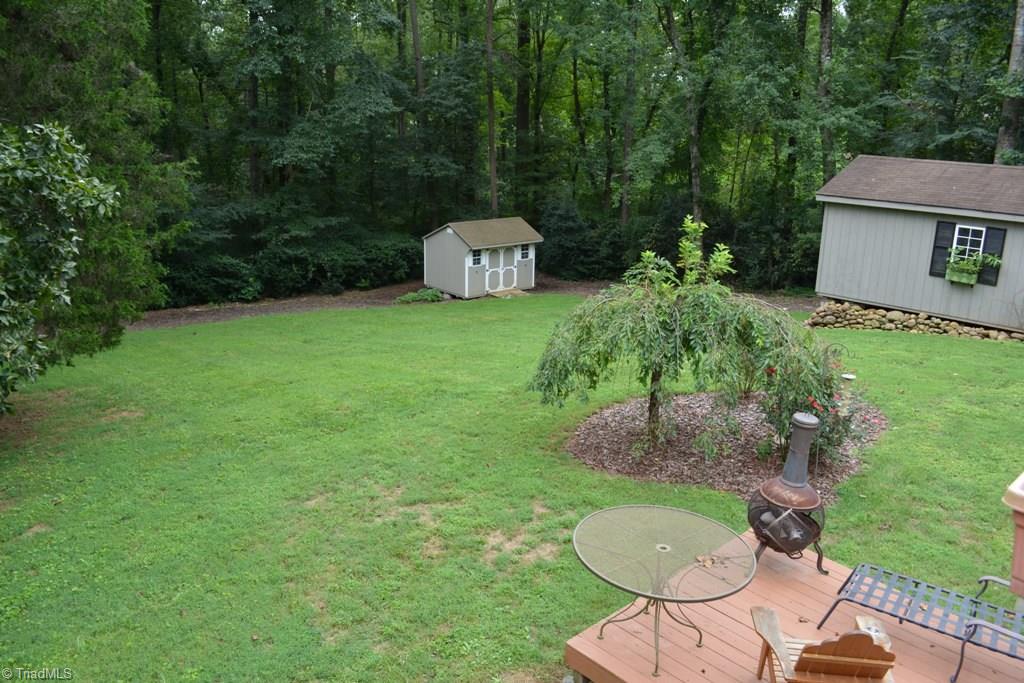 2582 Little Elkin Church Road Ronda, NC 28670 - Photo 9 of 30 Great back yard. Nice landscaping, extra sitting area under the deck, and 2 storage buildings.