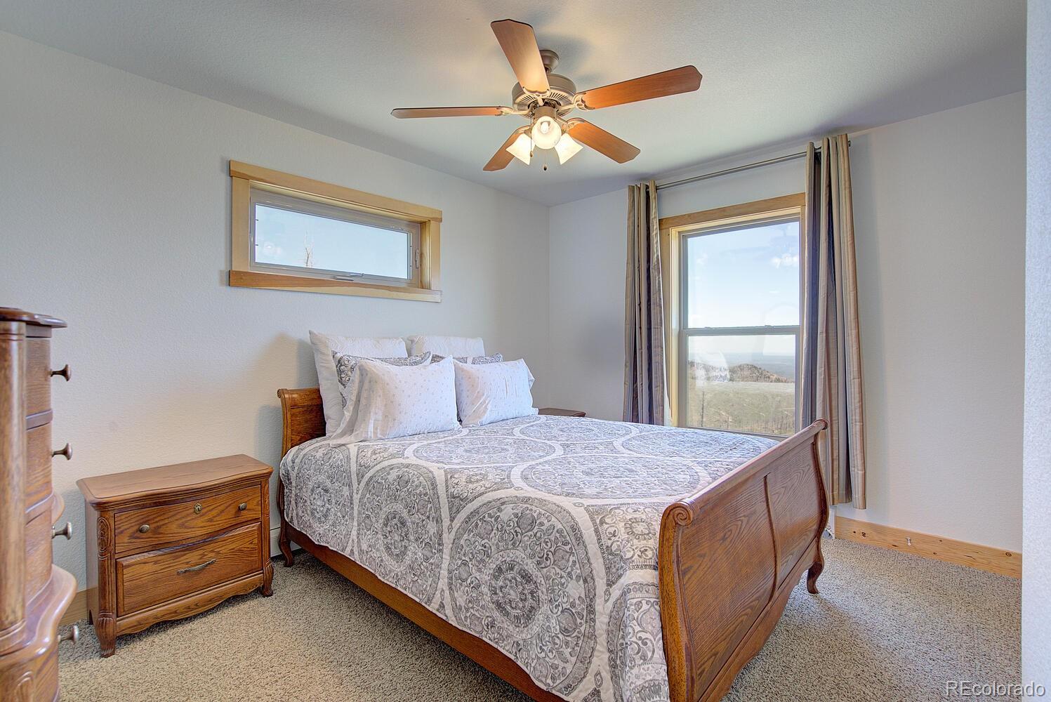 4111 Davis Ranch Road Bellvue, CO 80512 - Photo 23 of 38 a bedroom with a bed and a window