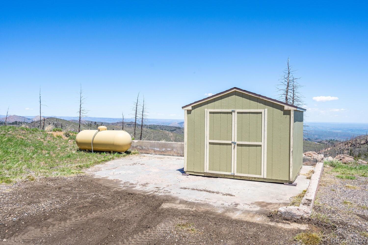 4111 Davis Ranch Road Bellvue, CO 80512 - Photo 34 of 38 a view of a house with a backyard