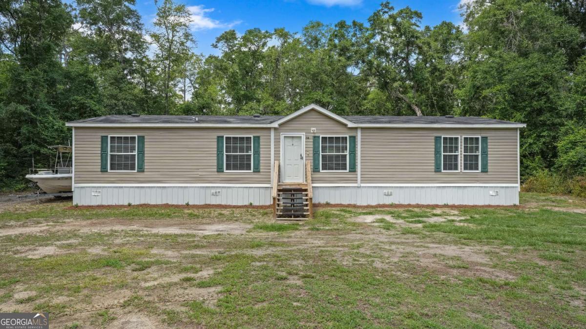 a house that has a big yard in front of it