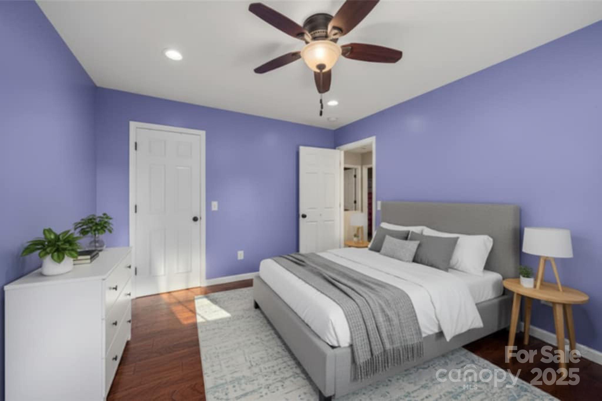 2341 Enola Road Morganton, NC 28655 - Photo 27 of 48 a bedroom with a bed chandelier and a potted plant