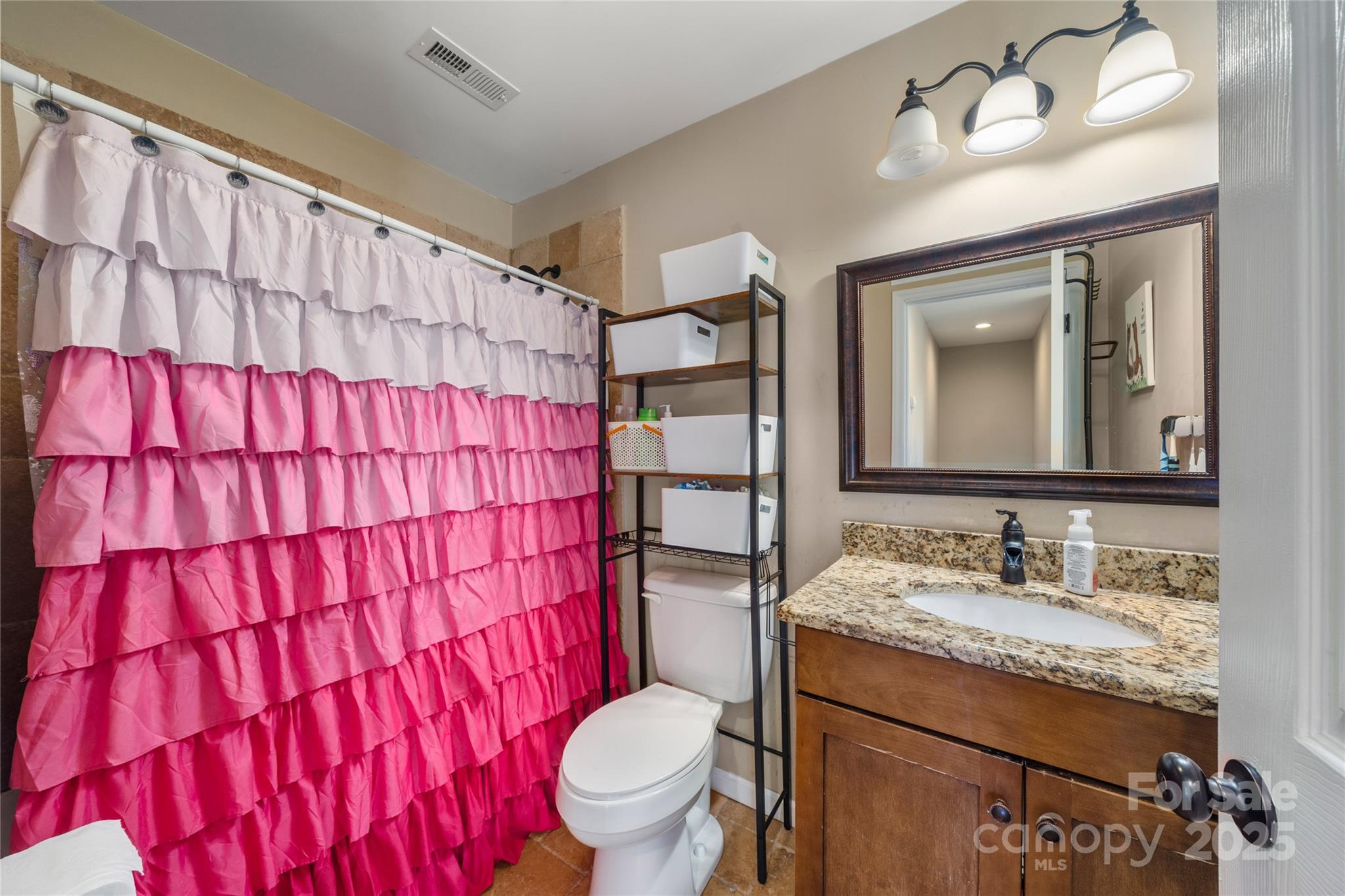 2341 Enola Road Morganton, NC 28655 - Photo 31 of 48 a bathroom with a granite countertop sink vanity mirror and toilet