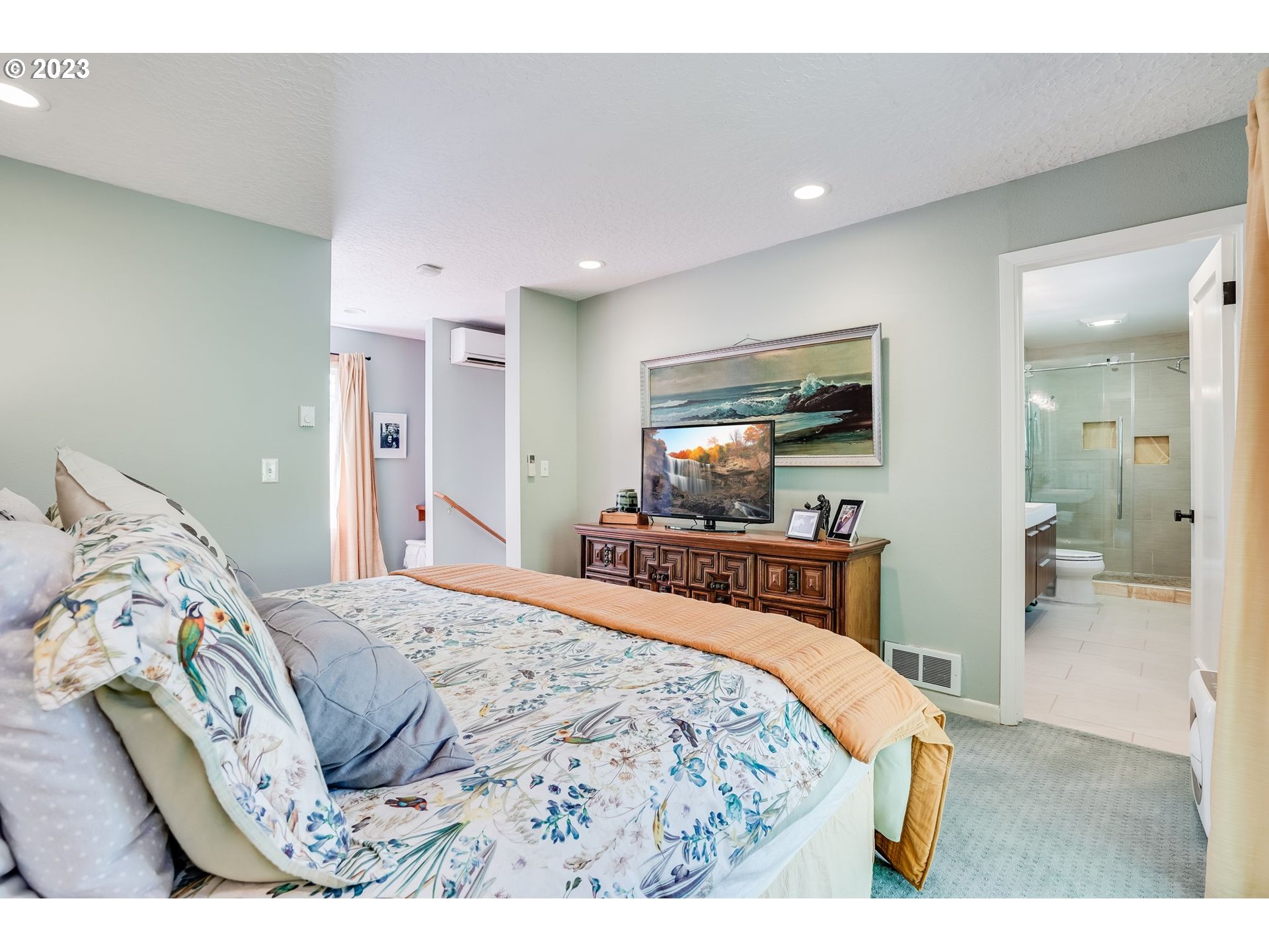 644 South Palatine Hill Road Portland, OR 97219 - Photo 19 of 46 a bedroom with a bed and a large mirror