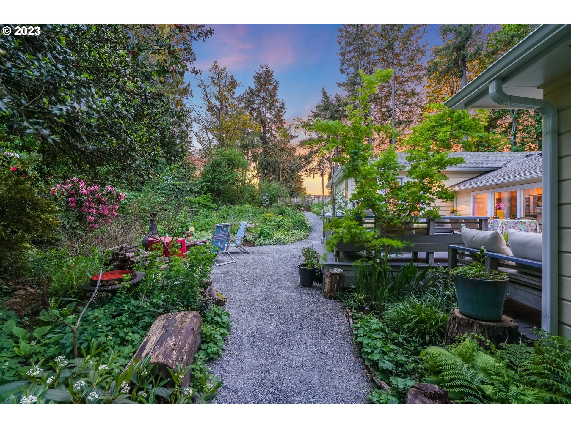 644 South Palatine Hill Road Portland, OR 97219 - Photo 35 of 46 a view of a backyard with potted plants and large tree