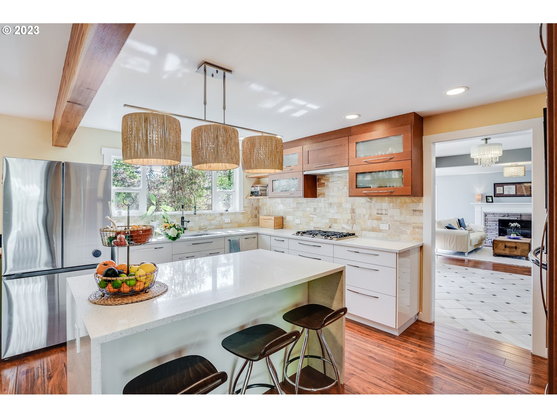 644 South Palatine Hill Road Portland, OR 97219 - Photo 7 of 46 a kitchen with stainless steel appliances kitchen island granite countertop a refrigerator a stove and white cabinets with wooden floor