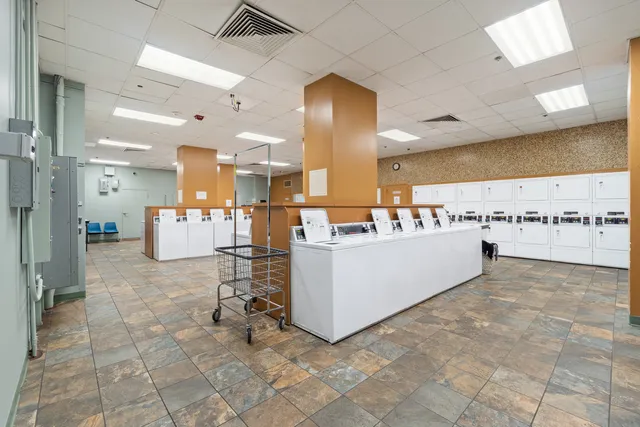 a large white kitchen with kitchen island a sink a stove and a refrigerator
