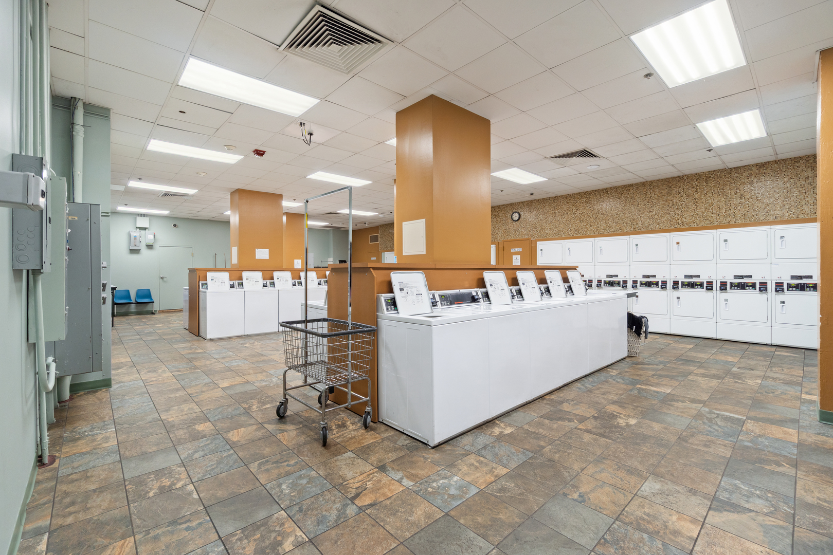211 East Ohio Street, Unit 2806 Chicago, IL 60611 - Photo 11 of 16 a large white kitchen with kitchen island a sink a stove and a refrigerator