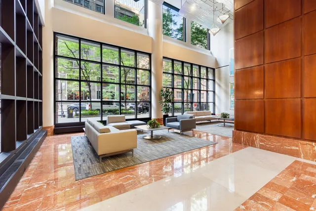 a living room with furniture and floor to ceiling windows