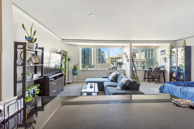 a living room with furniture and a floor to ceiling window