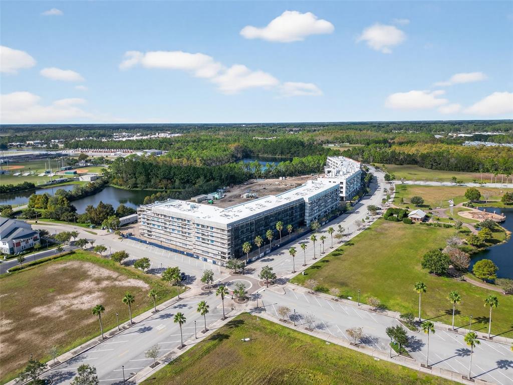 469 Bulldog Drive, Unit 1 Palm Coast, FL 32164 - Photo 47 of 54 a view of a lake with lawn chairs and large trees