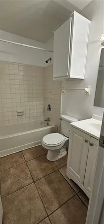 a bathroom with a toilet a sink and shower