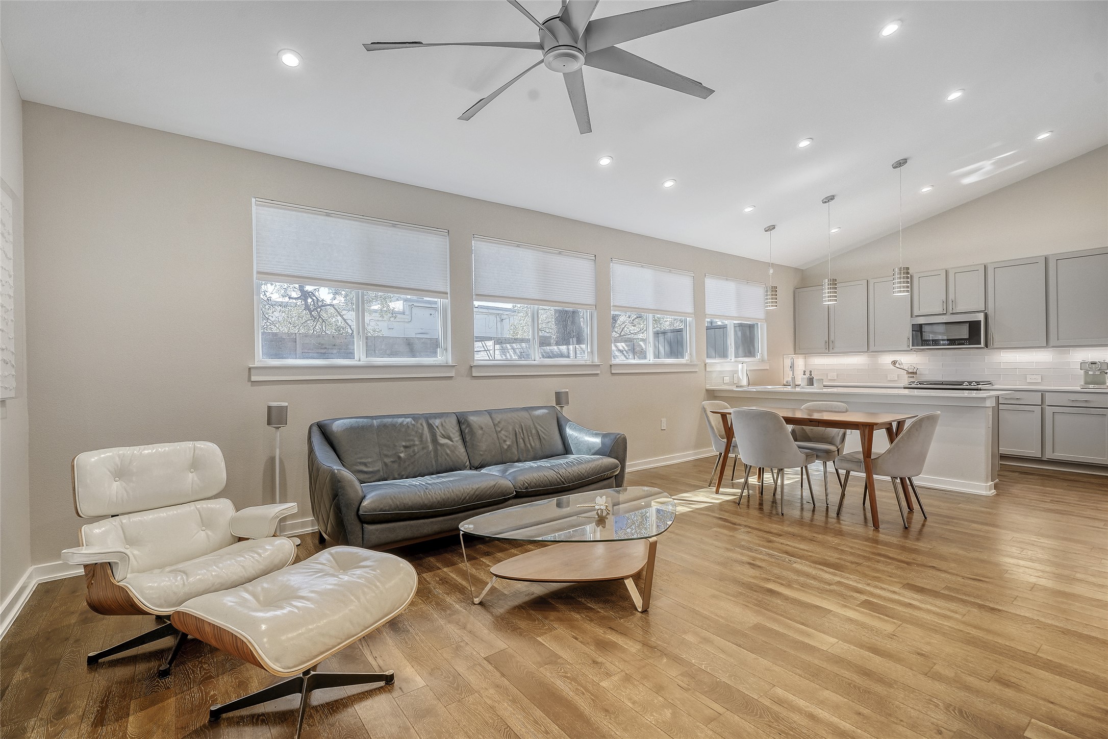 6800 Menchaca Road, Unit 5 Austin, TX 78745 - Photo 12 of 28 a living room with furniture and a dining table with wooden floor