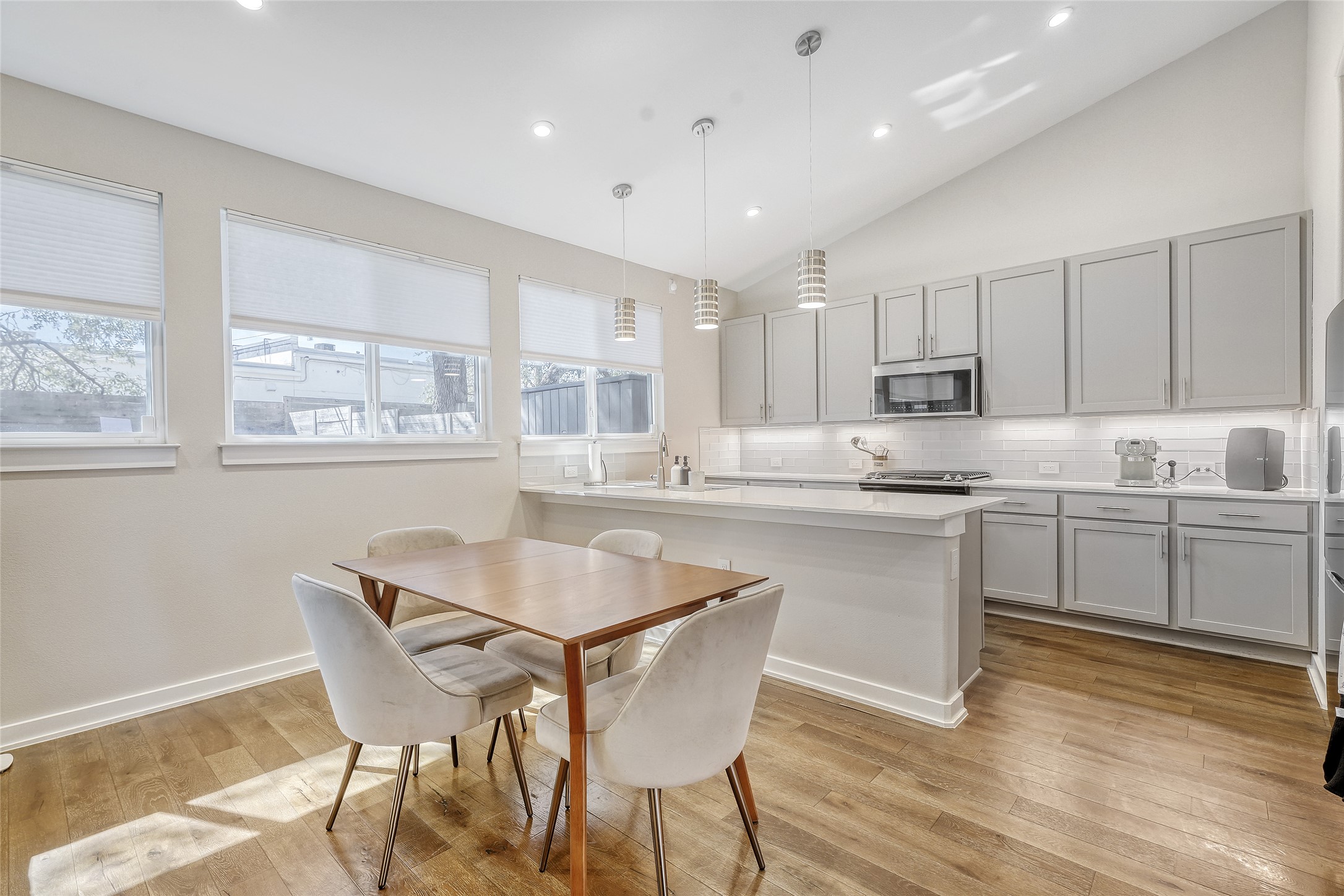 6800 Menchaca Road, Unit 5 Austin, TX 78745 - Photo 2 of 28 a kitchen with kitchen island white cabinets and wooden floor