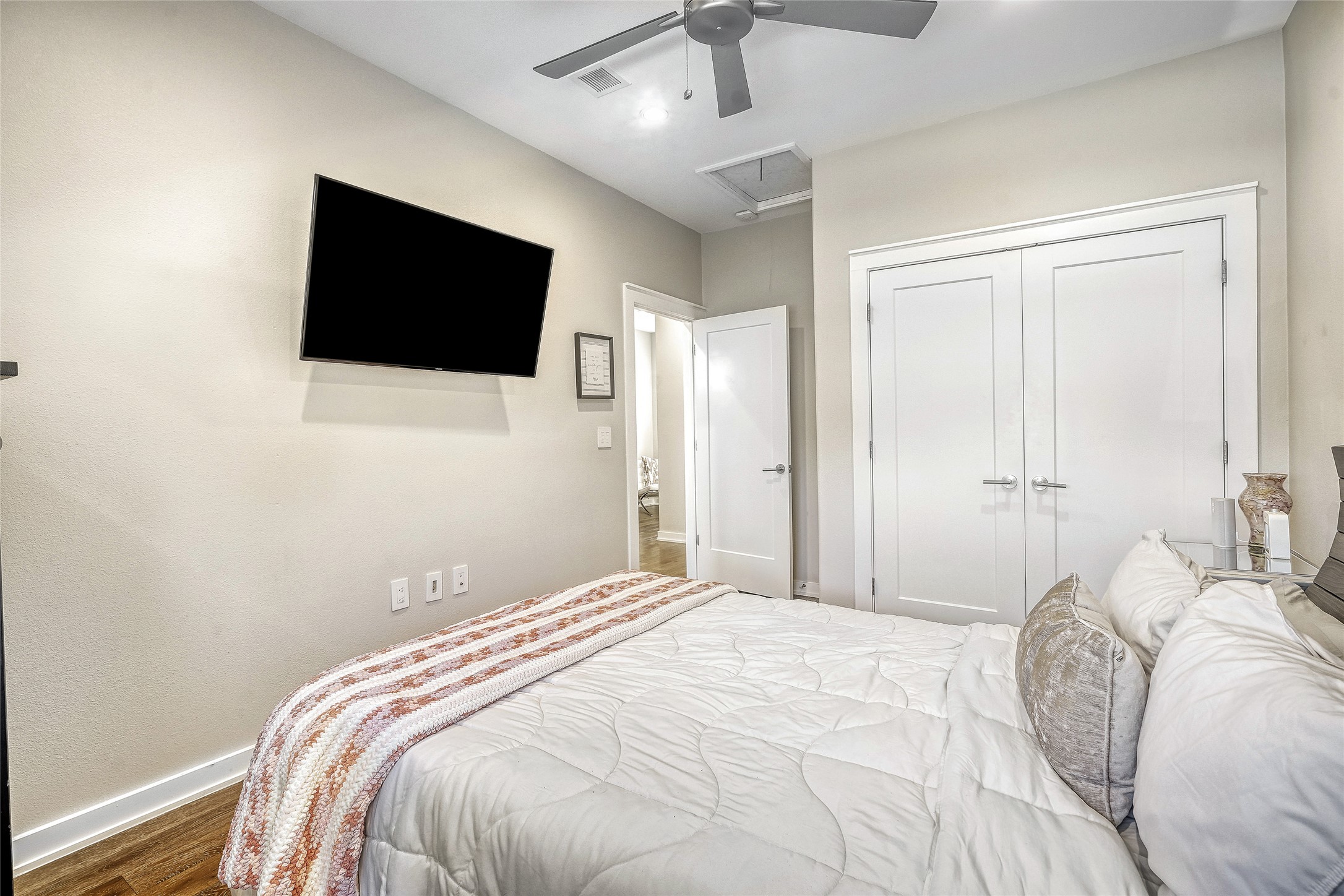 6800 Menchaca Road, Unit 5 Austin, TX 78745 - Photo 22 of 28 a bedroom with a bed and a flat screen tv