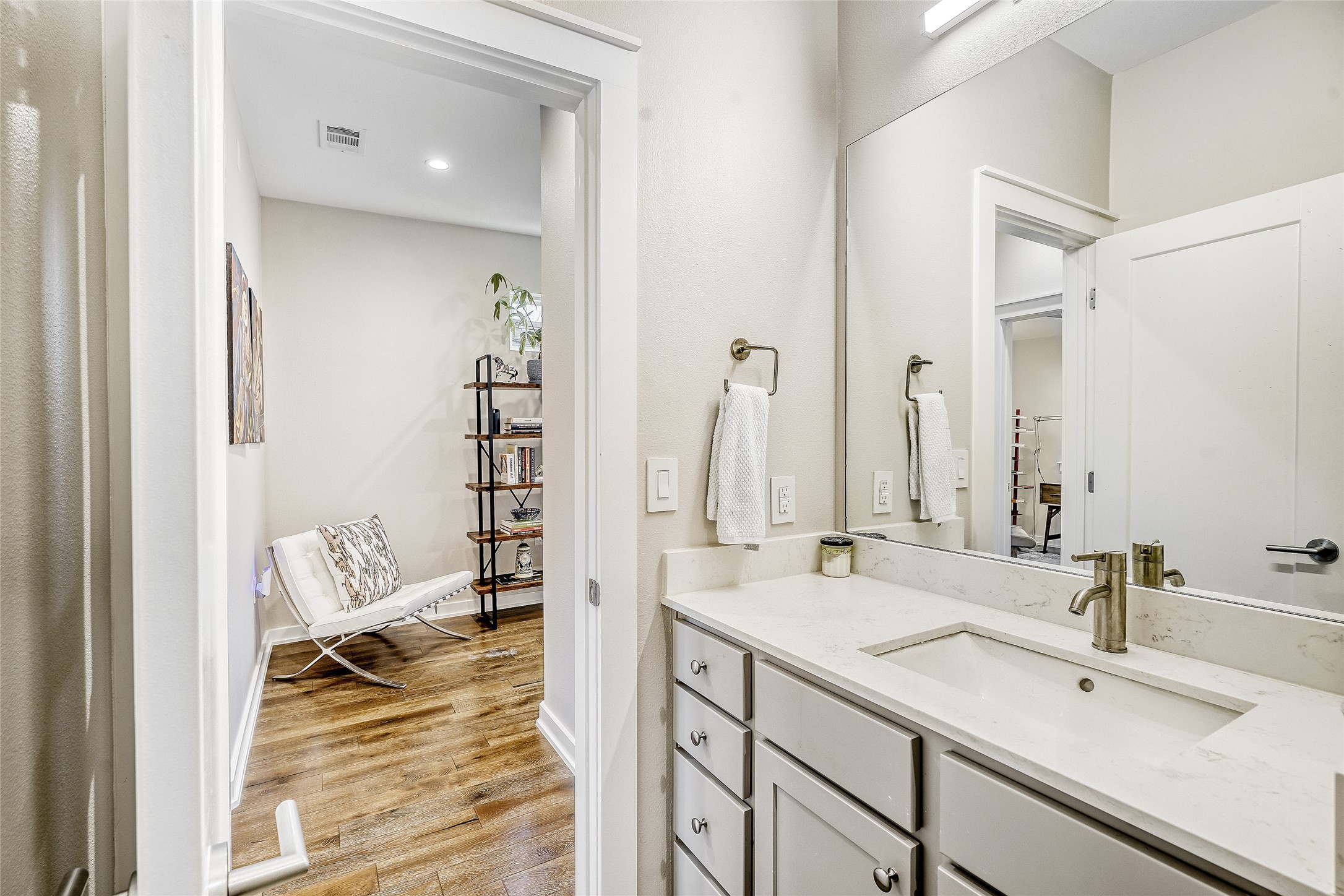 6800 Menchaca Road, Unit 5 Austin, TX 78745 - Photo 25 of 28 a bathroom with a double vanity sink a mirror and a shower