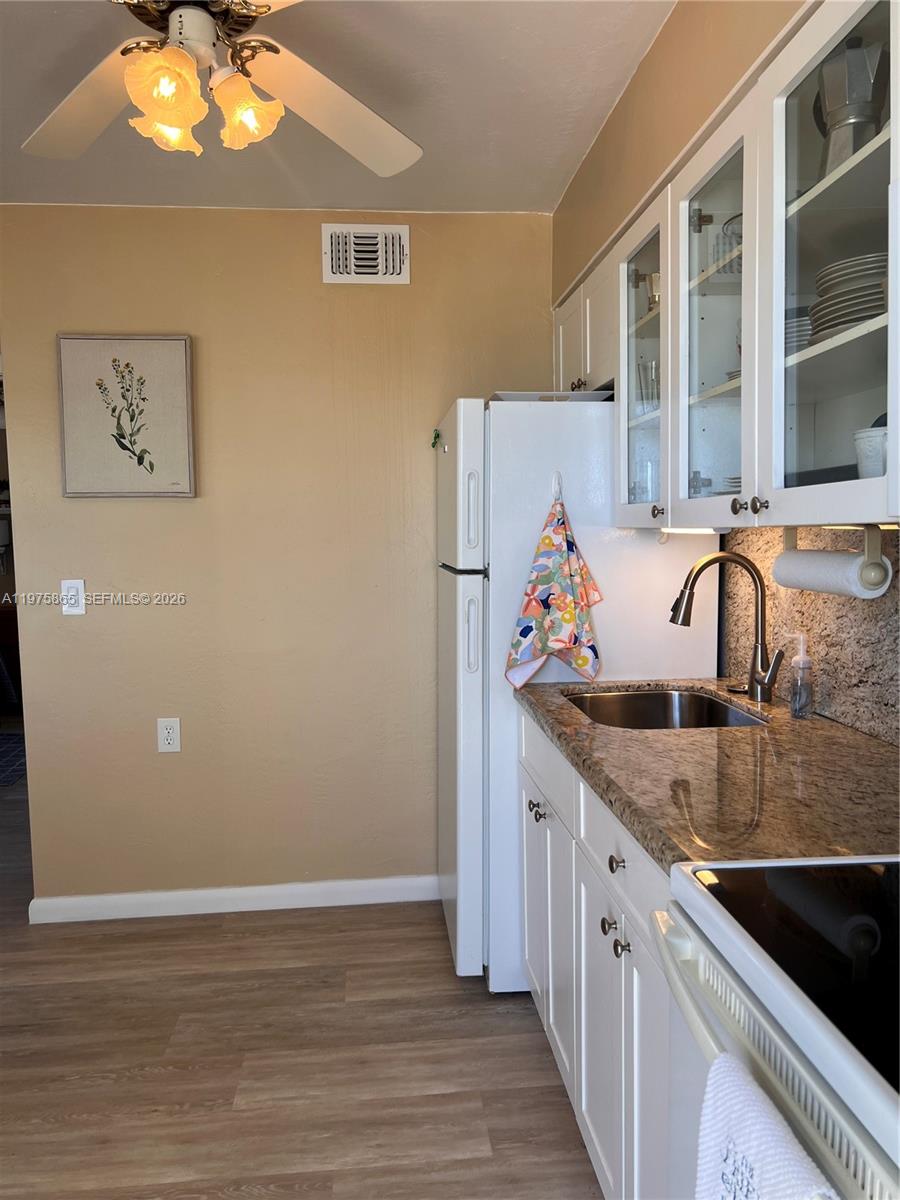 2600 North Surf Road, Unit 403 Hollywood, FL 33019 - Photo 11 of 24 a kitchen with a sink and cabinets