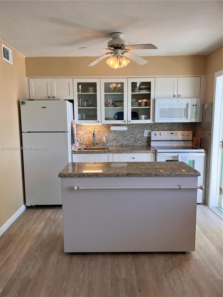 2600 North Surf Road, Unit 403 Hollywood, FL 33019 - Photo 12 of 24 a living room with granite countertop kitchen island a large counter top space and a window