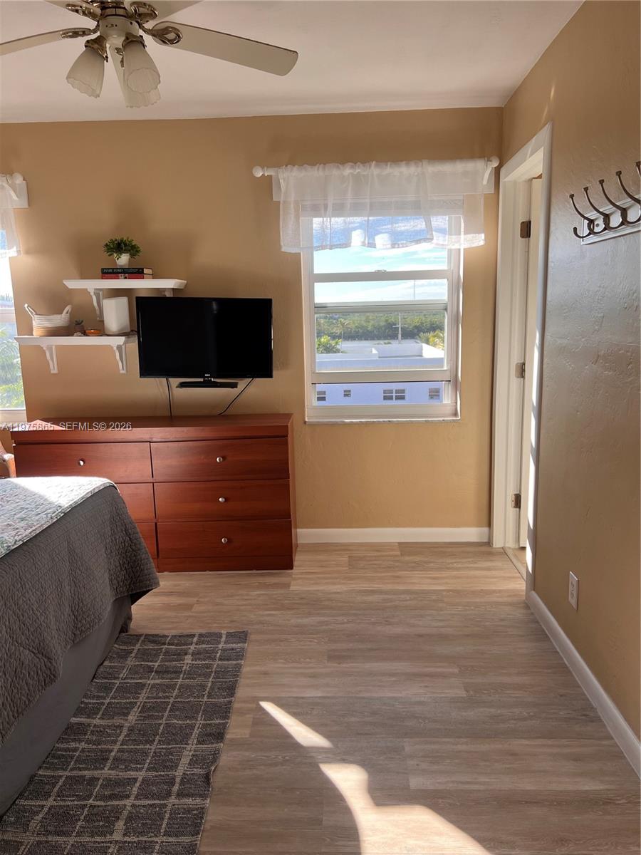 2600 North Surf Road, Unit 403 Hollywood, FL 33019 - Photo 15 of 24 a living room with a bed furniture and a flat screen tv