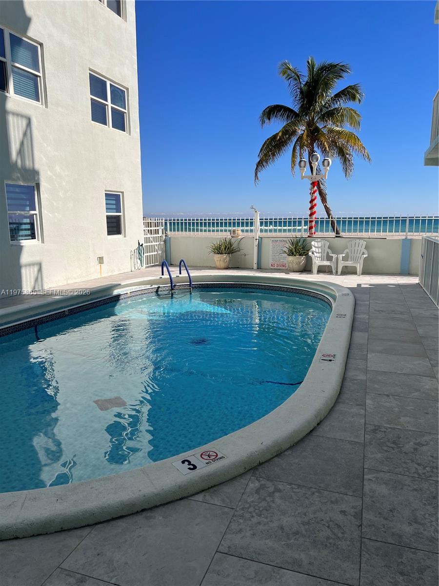 2600 North Surf Road, Unit 403 Hollywood, FL 33019 - Photo 24 of 24 a view of a swimming pool with a table and chairs
