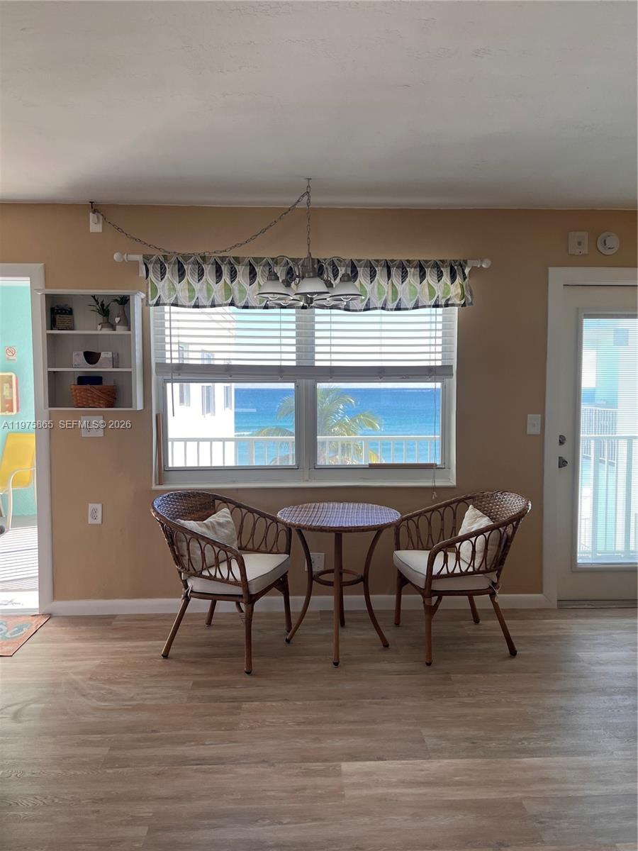 2600 North Surf Road, Unit 403 Hollywood, FL 33019 - Photo 7 of 24 a dining room with furniture and wooden floor