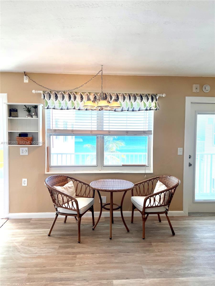2600 North Surf Road, Unit 403 Hollywood, FL 33019 - Photo 8 of 24 a dining room with furniture and wooden floor