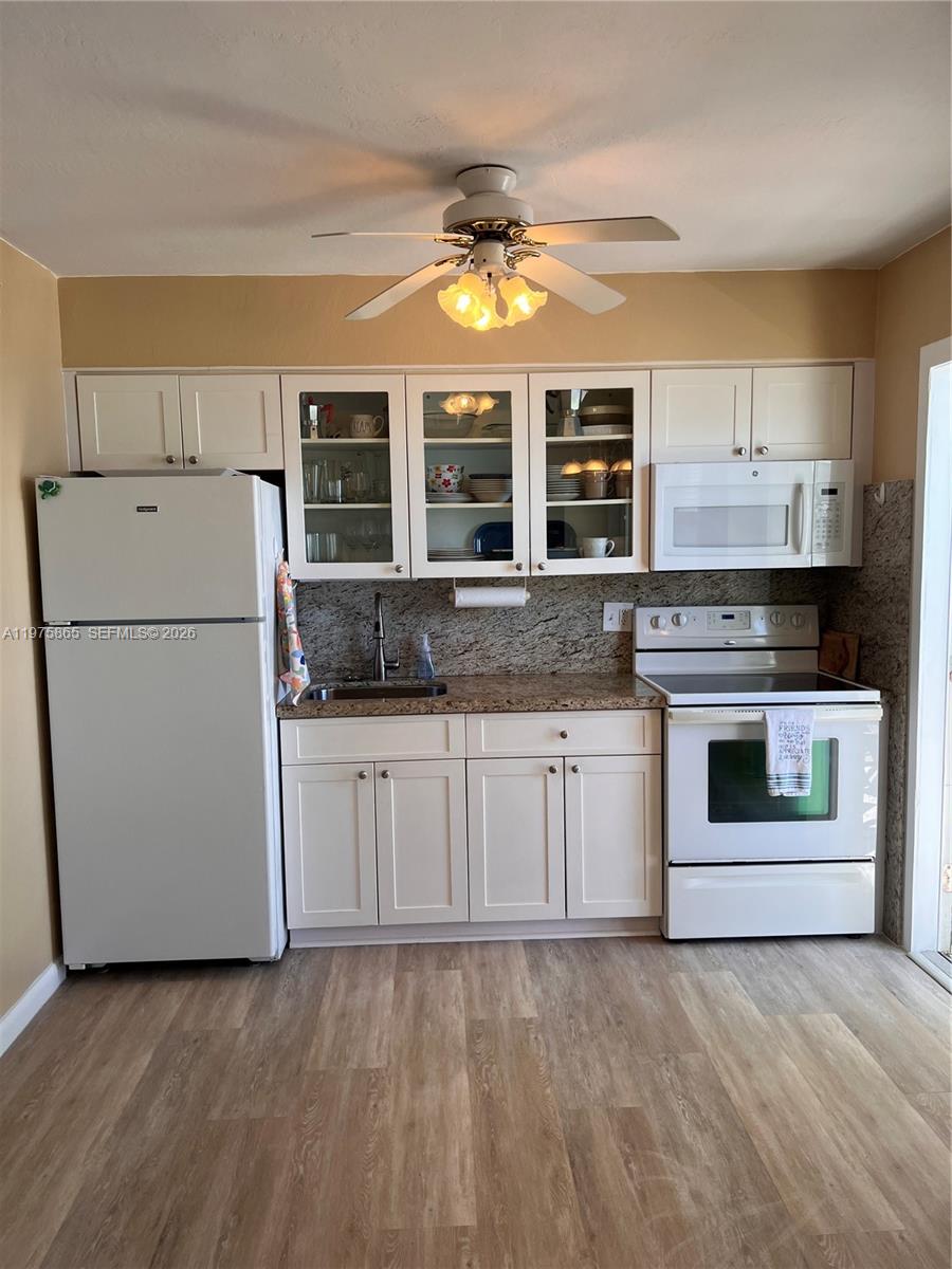 2600 North Surf Road, Unit 403 Hollywood, FL 33019 - Photo 9 of 24 a kitchen with stainless steel appliances granite countertop a stove and a refrigerator